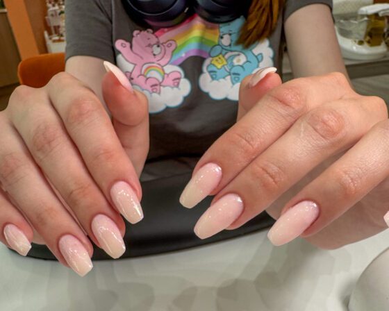 The same milky pink extensions closer in, showing the even gradient on each nail.