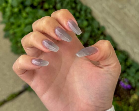 Close view of the translucent grey nails, with the nail bed visible through the colour.