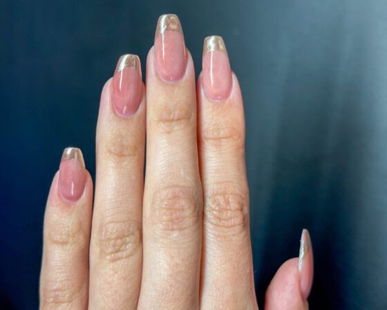 Fingers held straight, showing how the chrome edge follows the smile line on each nail.