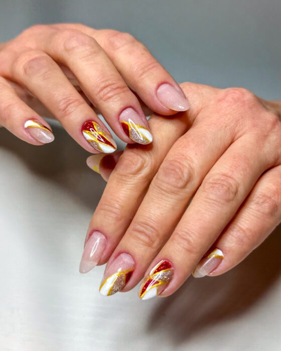 Close view of the same set, showing the freehand gold outlines and the glitter panel catching light.