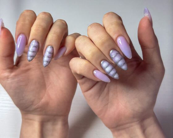 Closer view of an accent nail, the metallic outline tracing each cell in the stacked rows.