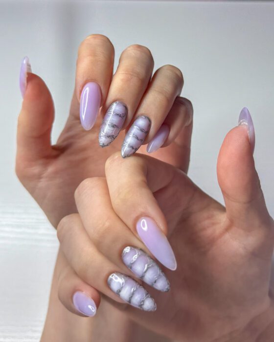Hands crossed, showing the even lilac colour running the full length of every nail.