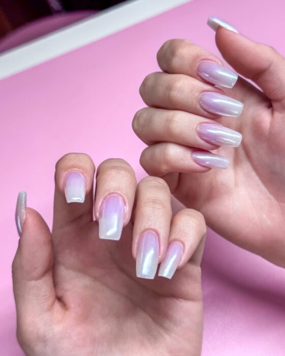 Both hands close together, the gradient starting at the cuticle on every nail.