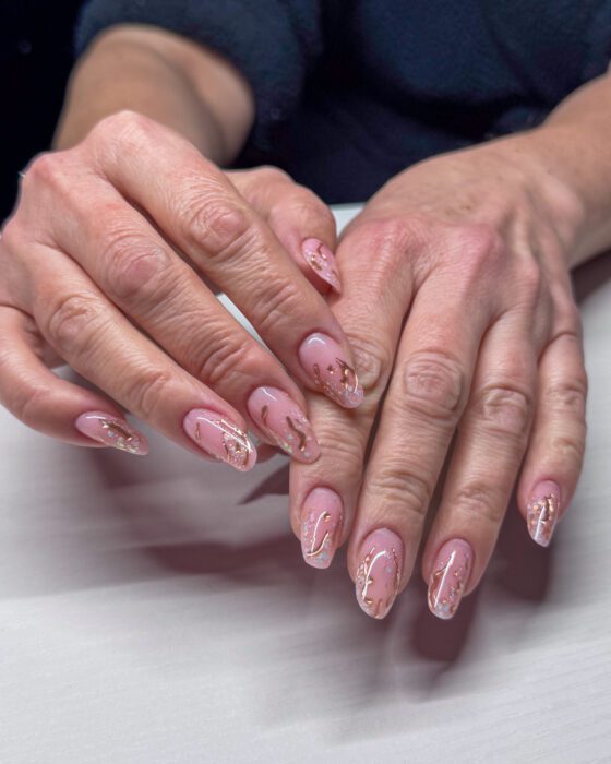 The same set from a second angle, showing how the gold placement changes from nail to nail.