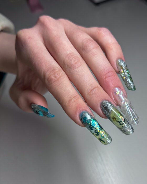 Turquoise carrying down the length of each extra-long oval nail.