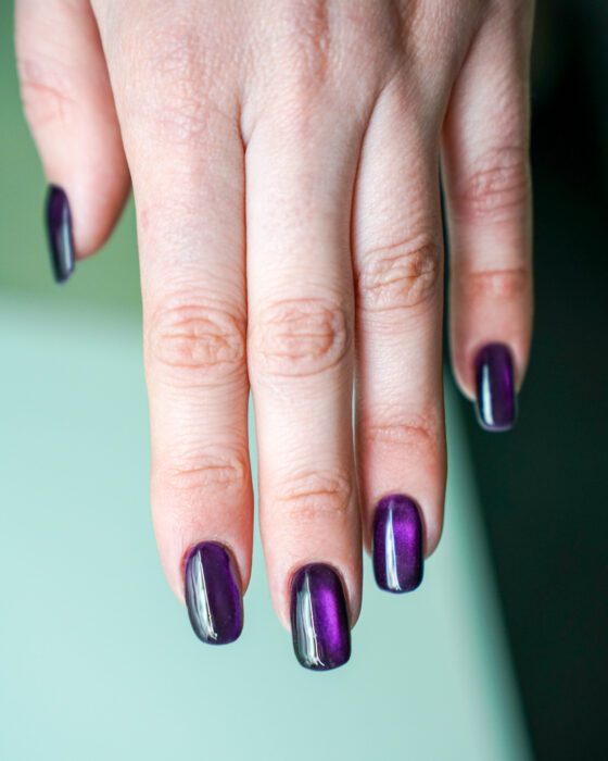 The purple hand showing the soft oval shape and the central reflective flare.