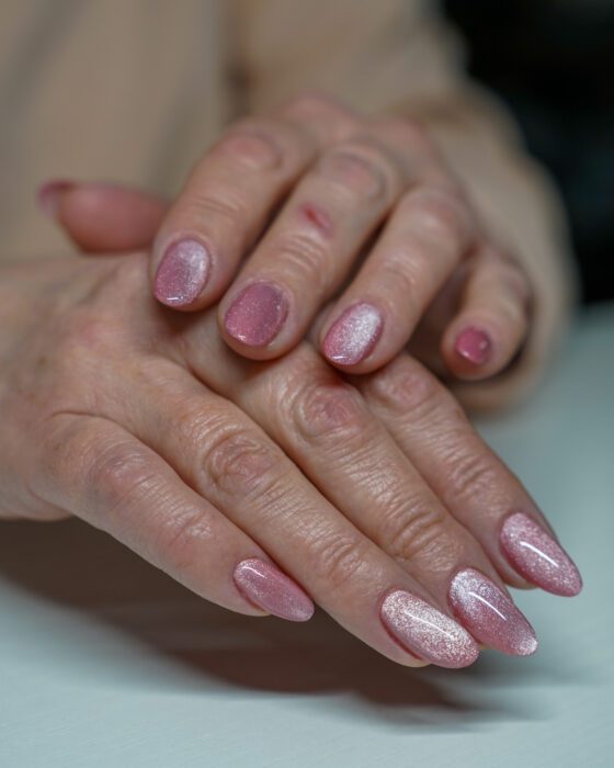 Both hands resting together, showing the soft oval shape and fine shimmer.