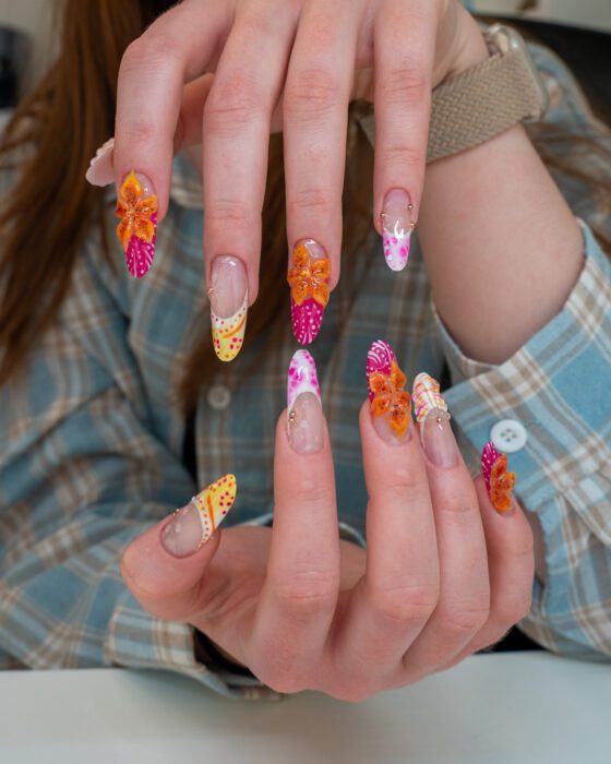 Hands raised, showing all ten designs at once.