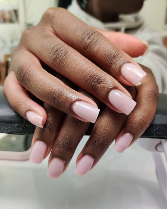 Medium square nails in a glossy soft nude pink.