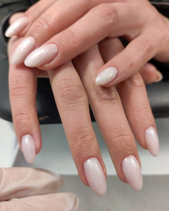 Medium almond nails in a uniform milky pearl-white gel finish.